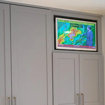 Sony OLED TV installed within kitchen cabinetry.