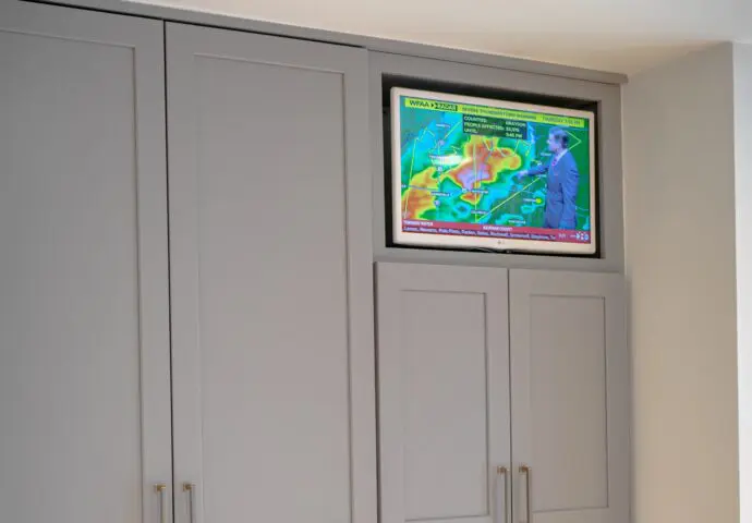 Sony OLED TV installed within kitchen cabinetry.