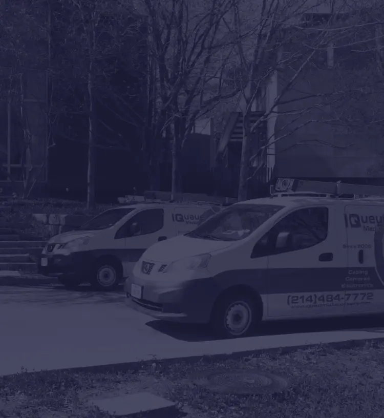 IQueue Media technician vans outside corporate office.