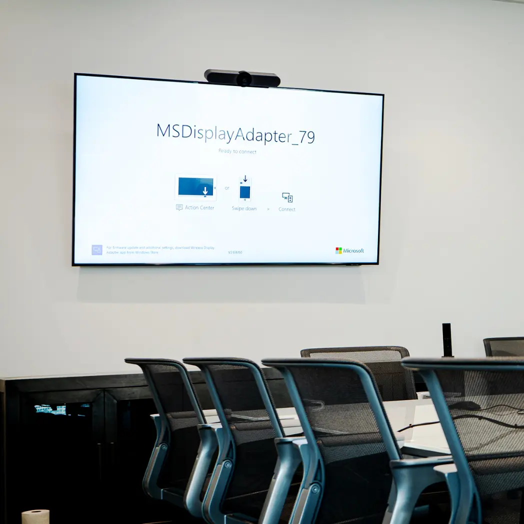 Microsoft programming of conference room screen with Logitech webcam and soundbar.