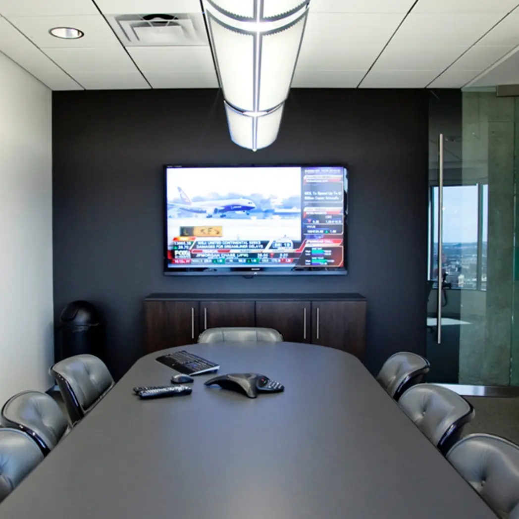 Office conference room AV setup with wireless keyboard, mouse, microphone and speaker.