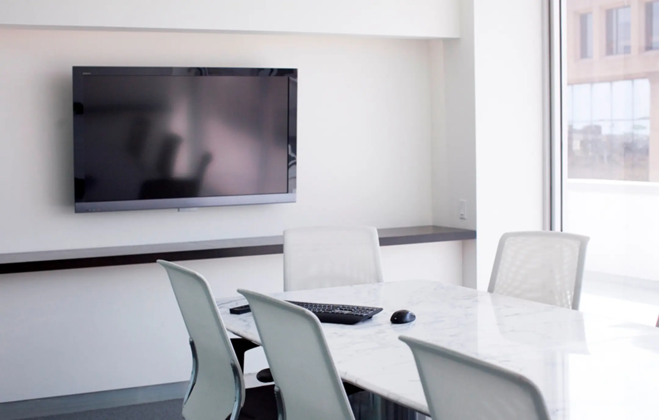 AV install in office conference room with white marble table.