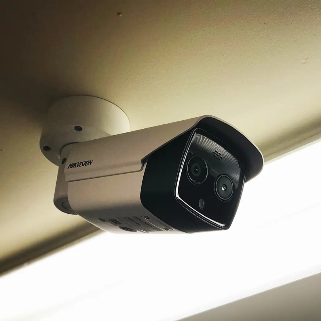 Ceiling mounted Hikvision surveillance system.