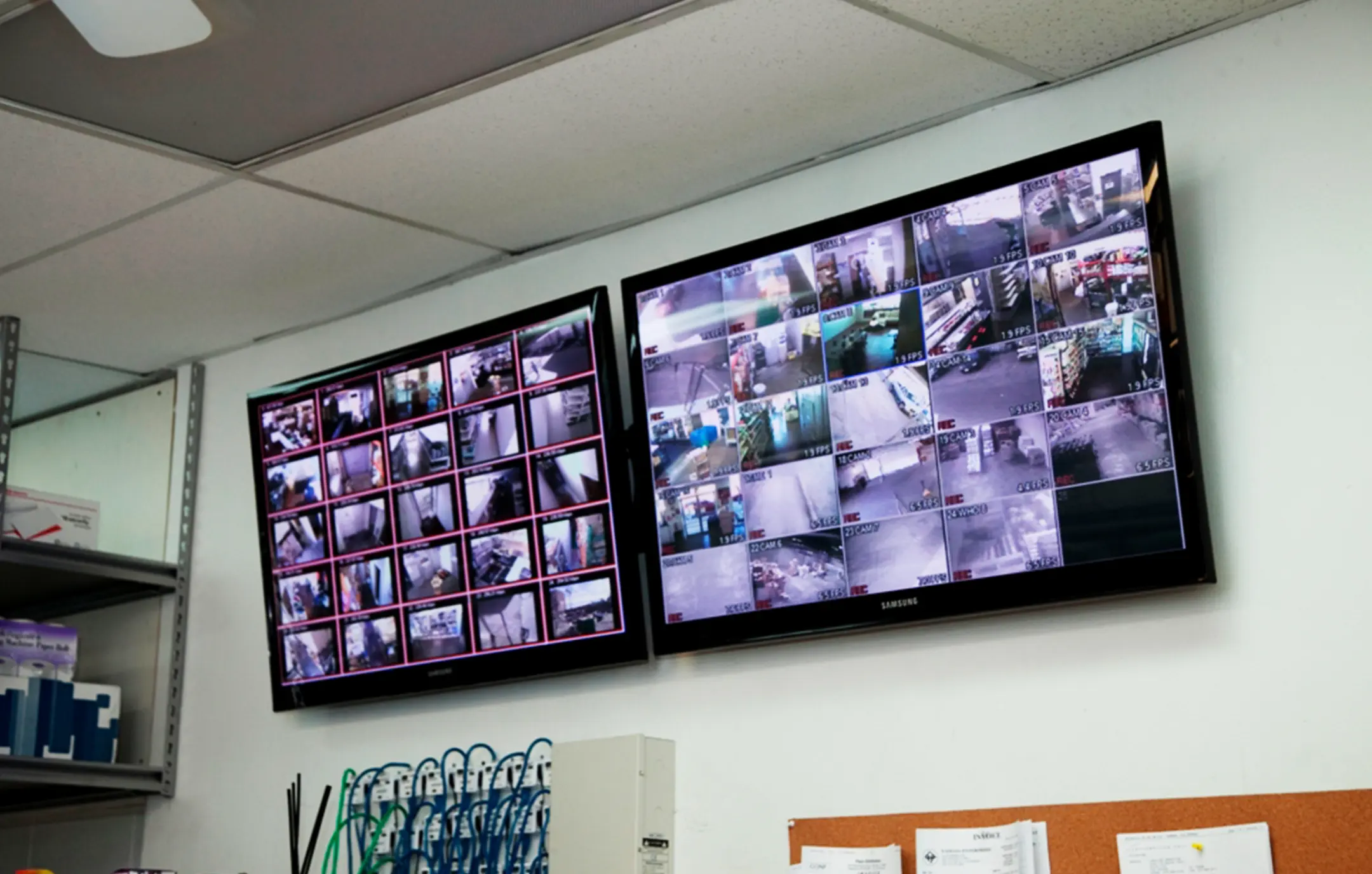 Industrial warehouse surveillance system monitors.