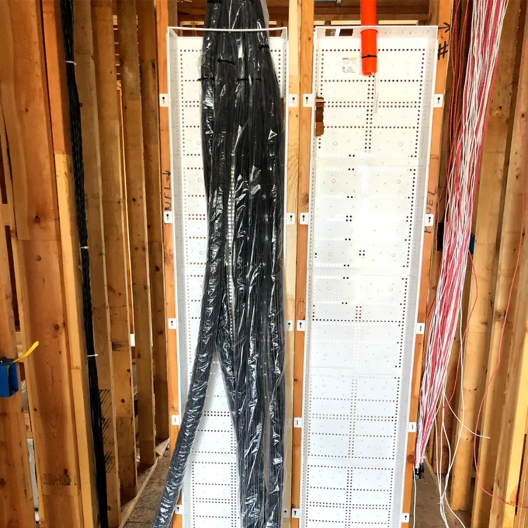 Cabling with plastic tubing for protection during home construction phase.