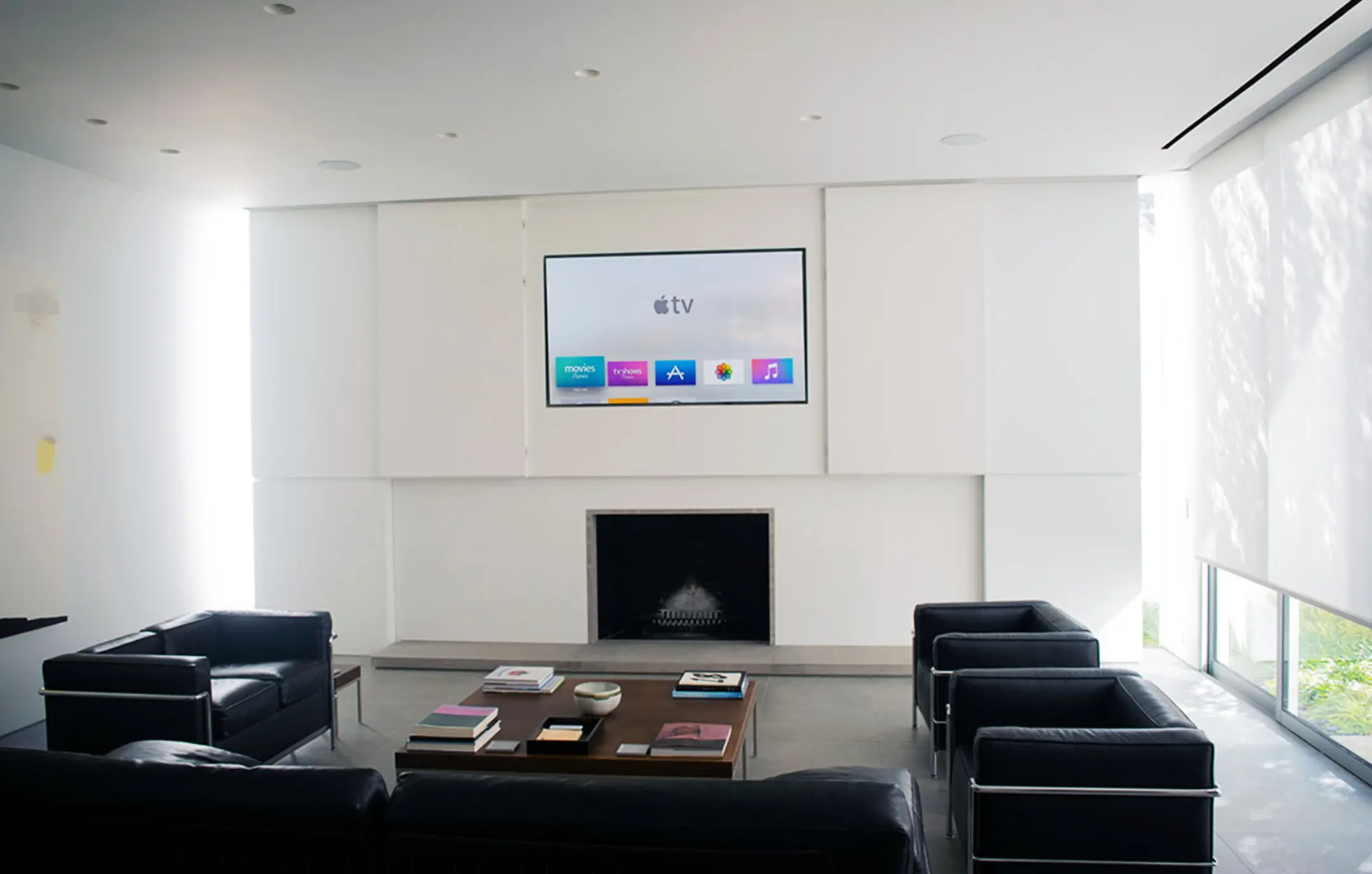 Apple TV installation and programming in corporate office lobby with seating and fireplace.