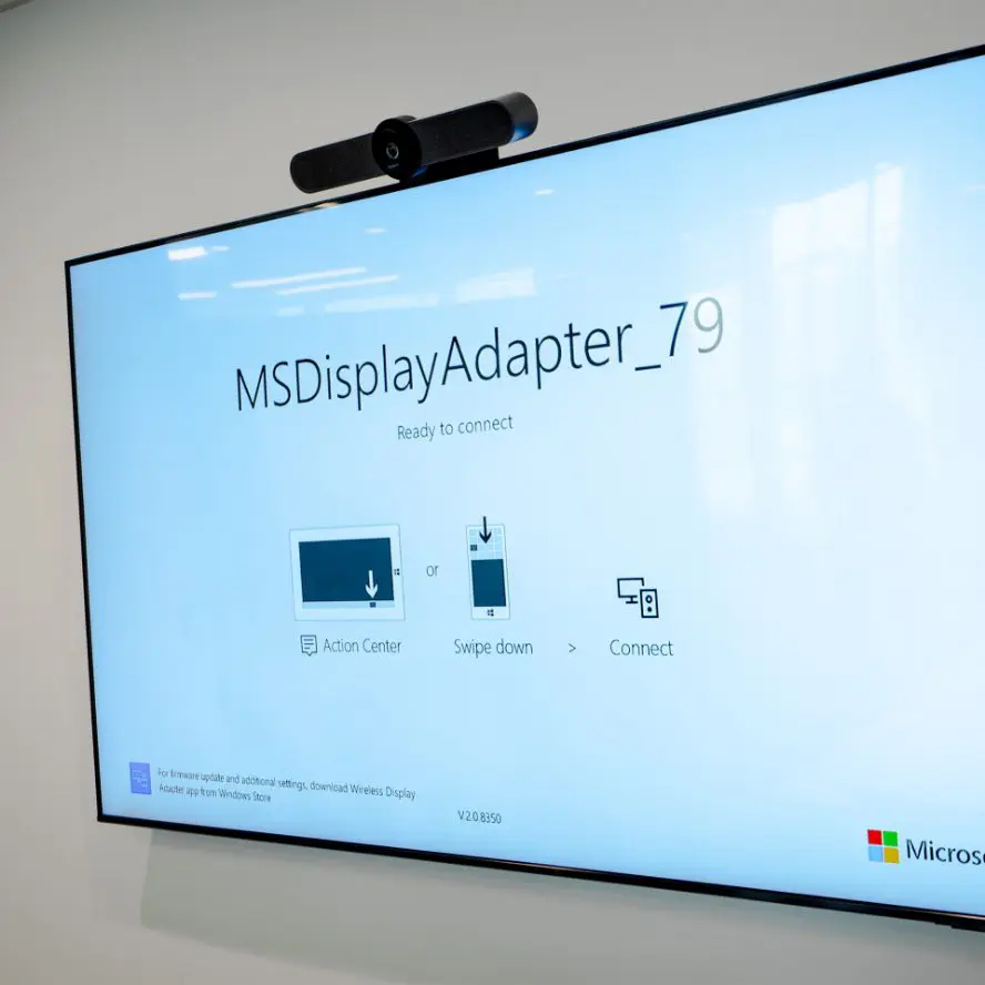 Office TV installation with Logitech webcam and soundbar.