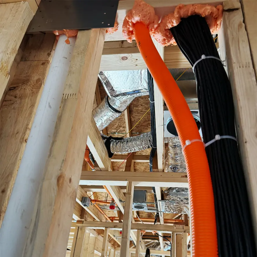 Cabling installation at new construction build with plastic tubing.