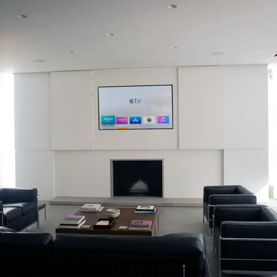 Apple TV installation and programming in corporate office lobby with seating and fireplace.