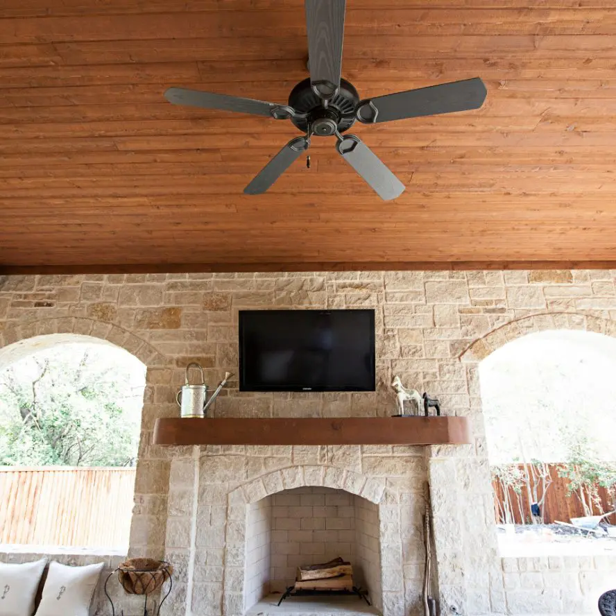 Outdoor living area with A/V installation above fireplace.