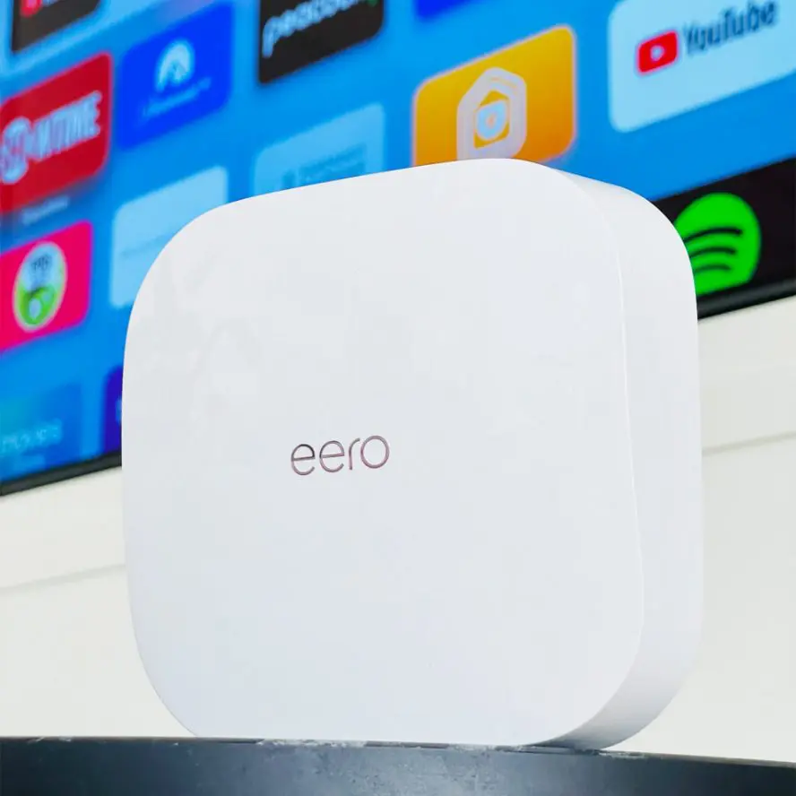 Eero WiFi extender displayed in front of screen.