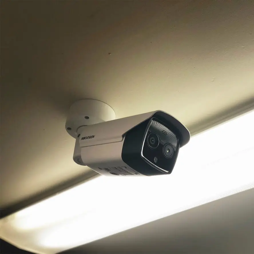 Home surveillance camera mounted to ceiling.