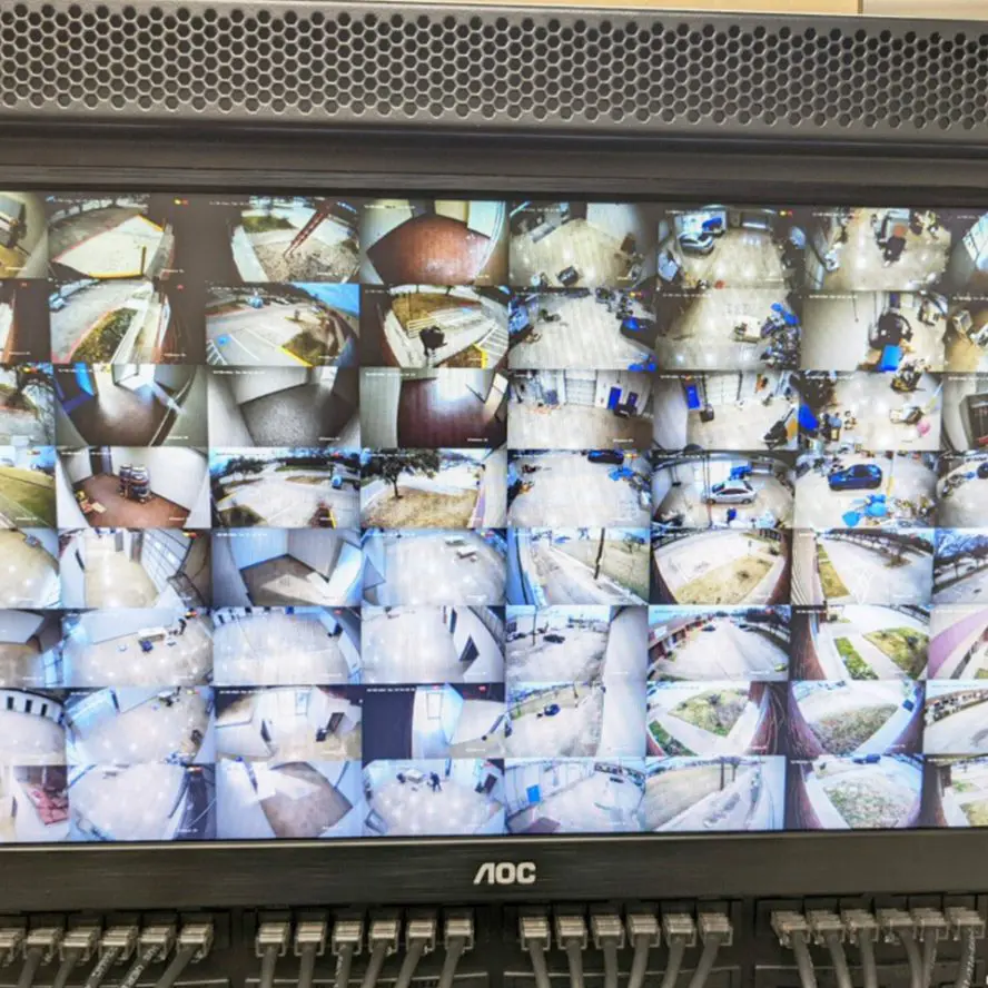 Home surveillance monitor showing various security camera views.